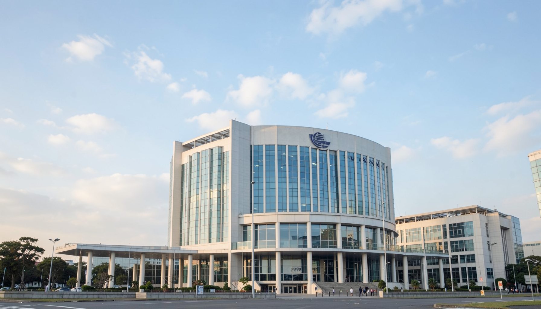 The United Nations headquarters building in soft morning light, pale blue sky with scattered clouds, clean diplomatic atmosphere