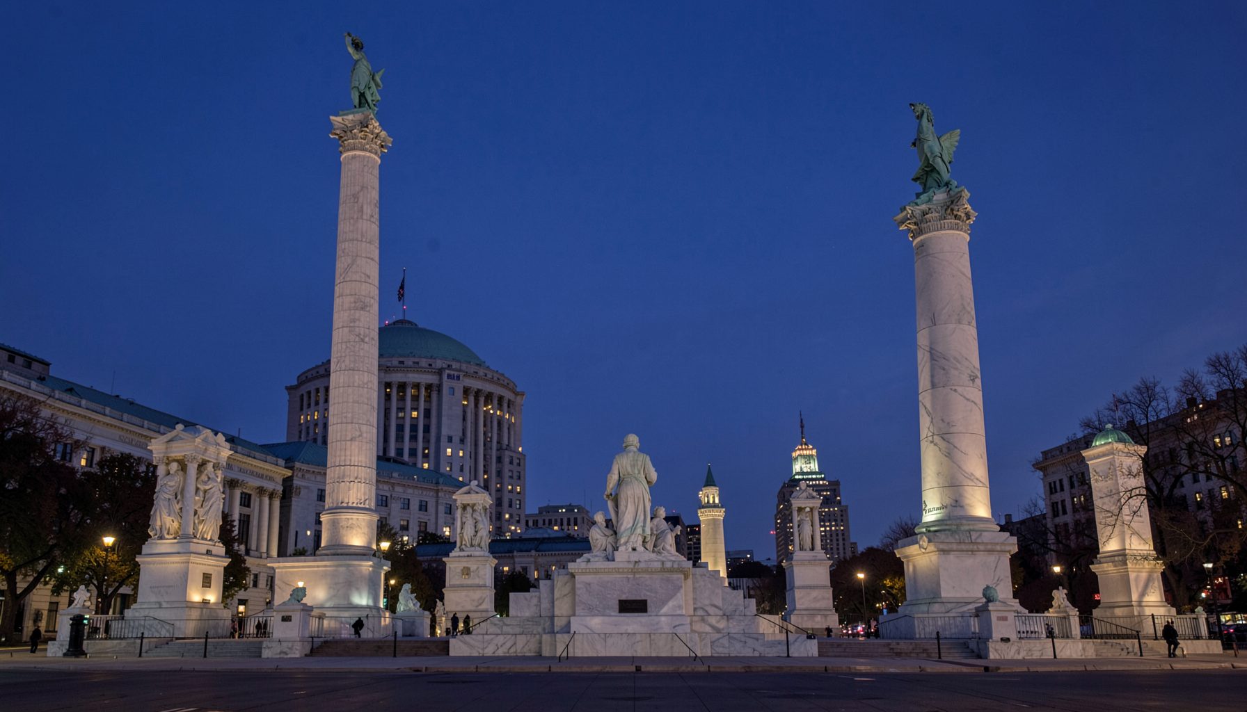 Washington D.C. monuments at twilight, marble tones glowing under a deep indigo sky, stately and calm
